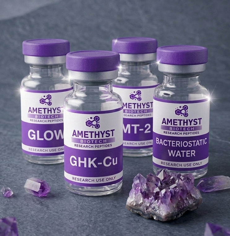 Four glass vials with purple caps labeled 'GLOW', 'GHK-Cu', 'MT-2', and 'Bacteriostatic Water' from Amethyst Biotech, placed on a dark surface with amethyst crystals nearby.